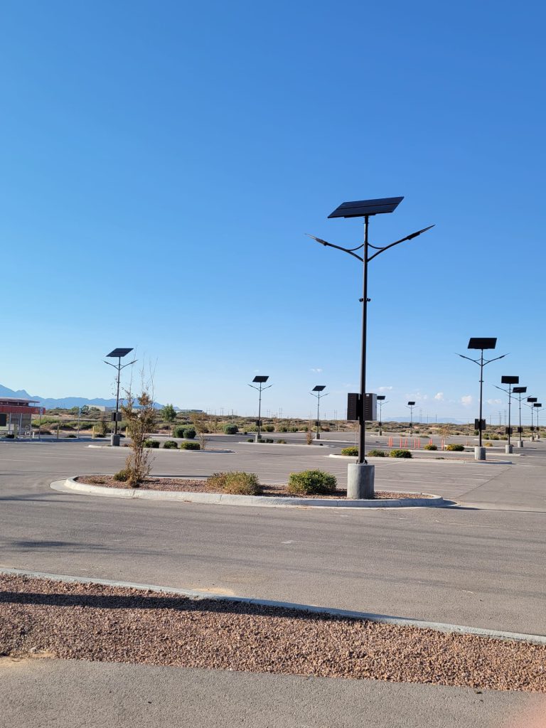 SolarPath solar street lights across a desert commercial lot in El Paso, Texas