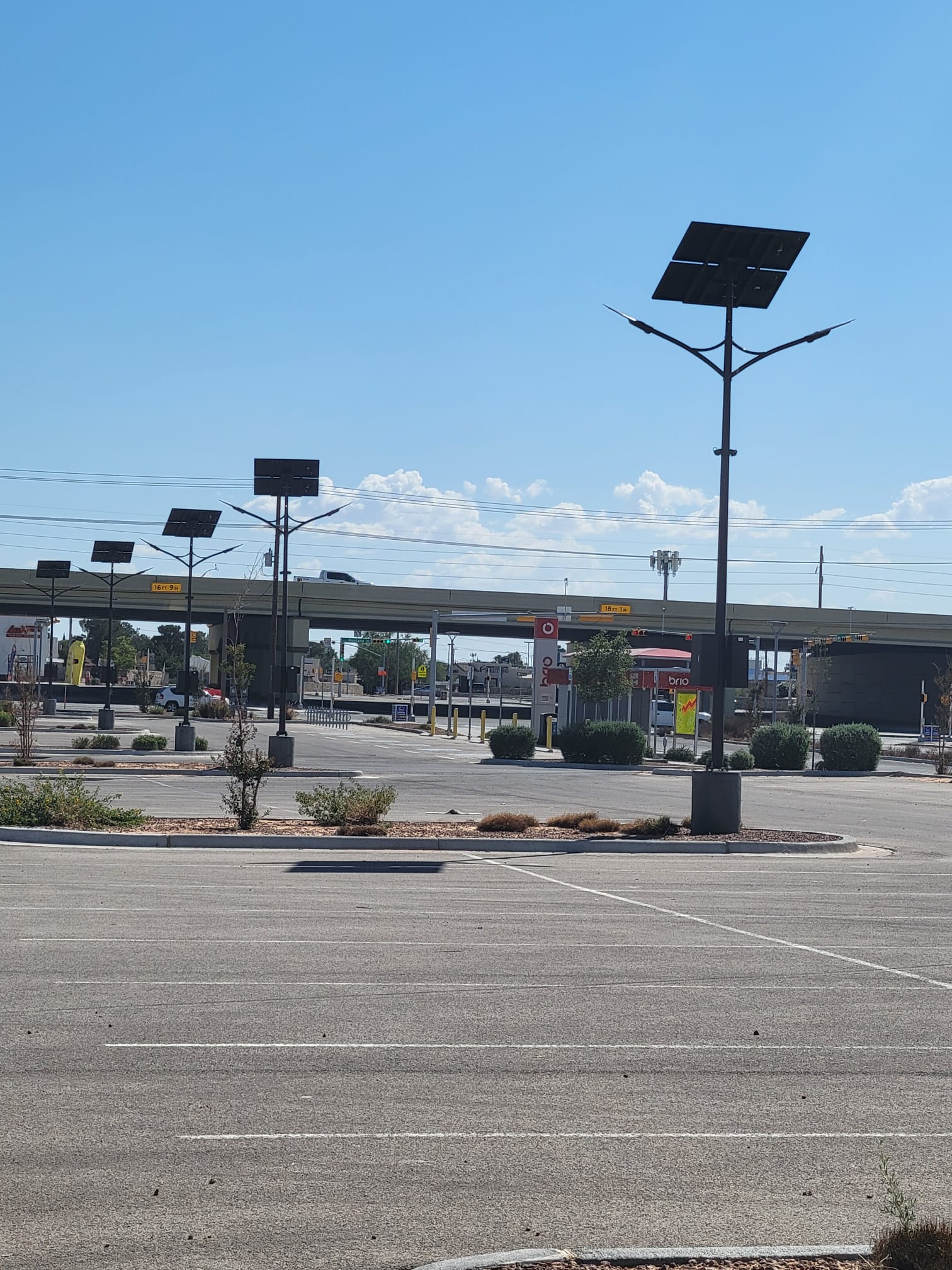 Array of SolarPath solar area lights across an El Paso parking lot with desert backdrop