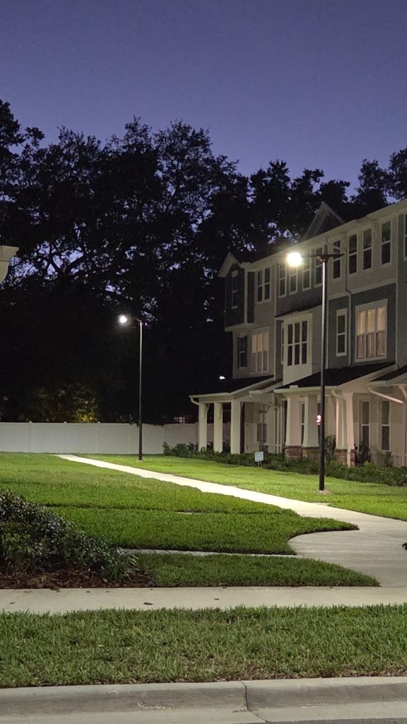 SolarPath solar street lights illuminating a townhome community at twilight