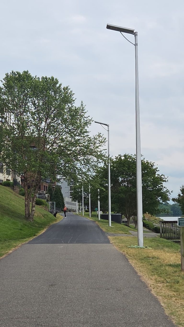 SolarPath all-in-one solar light along a riverside walking and bike trail
