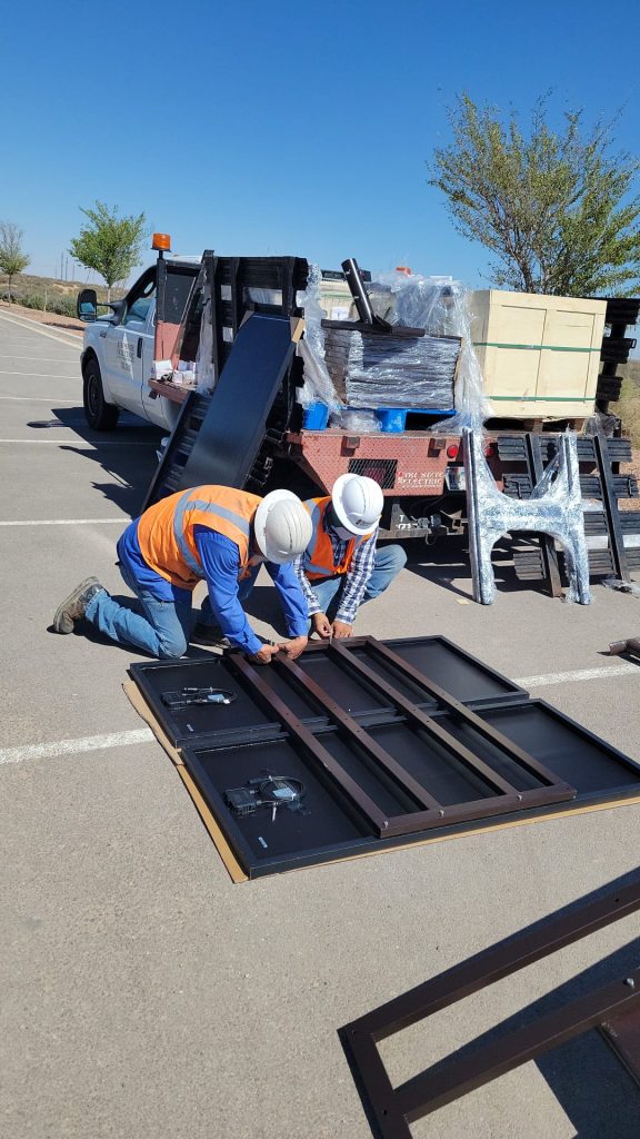 SolarPath installers assembling solar light fixtures on site