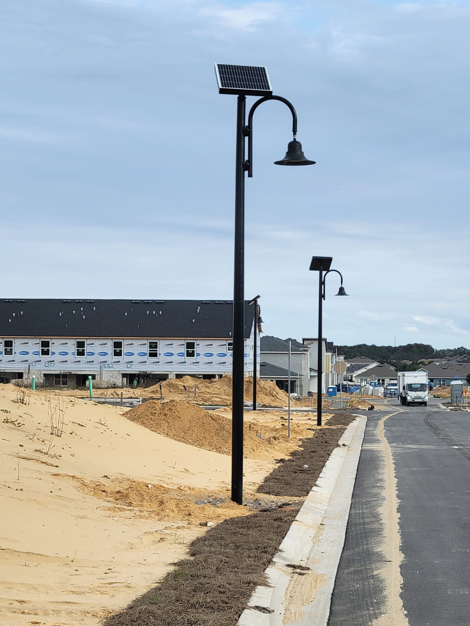 Decorative gooseneck solar street lights in a new community
