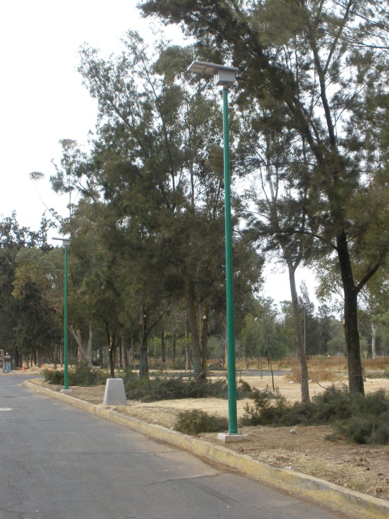 Solar pathway lights with visible panels along a recreational trail